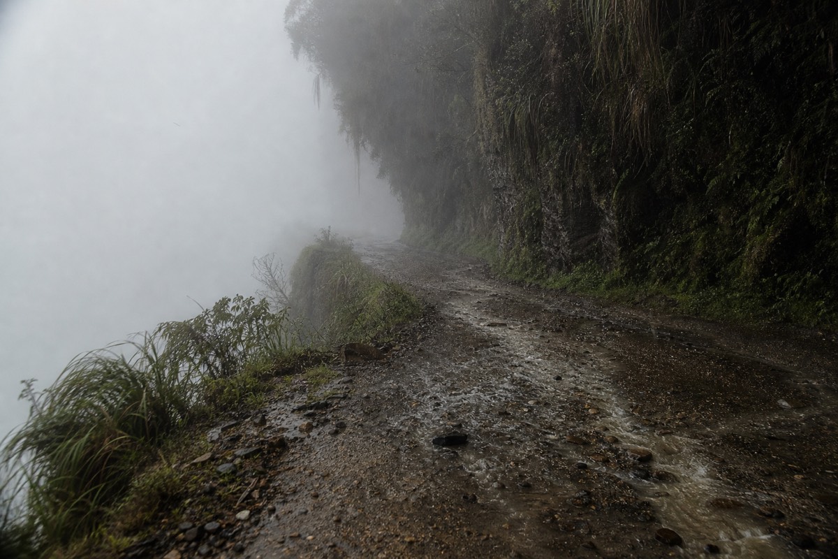 Fog and wet gravel on the Death Road in the rainy season