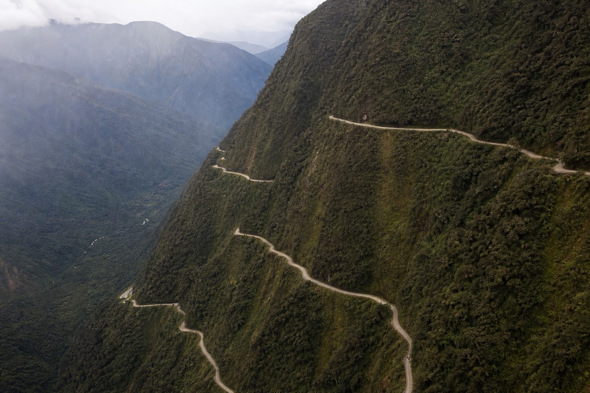 Aerial view of the Death Road switchbacking down the mountainside above the Yungas