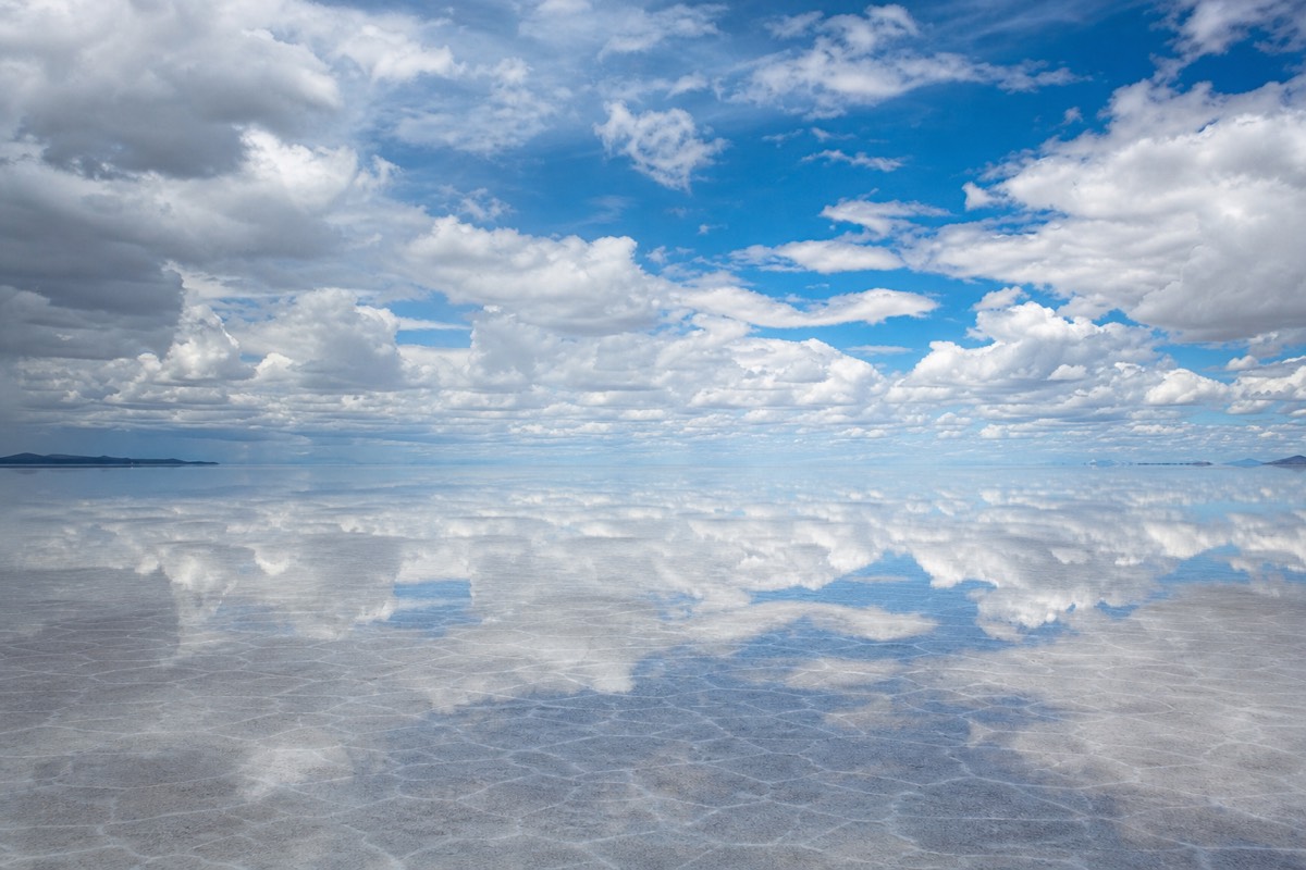 Mirror reflections on the flooded Uyuni salt flats at sunset, part of the Death Road and Uyuni combined Bolivia trip