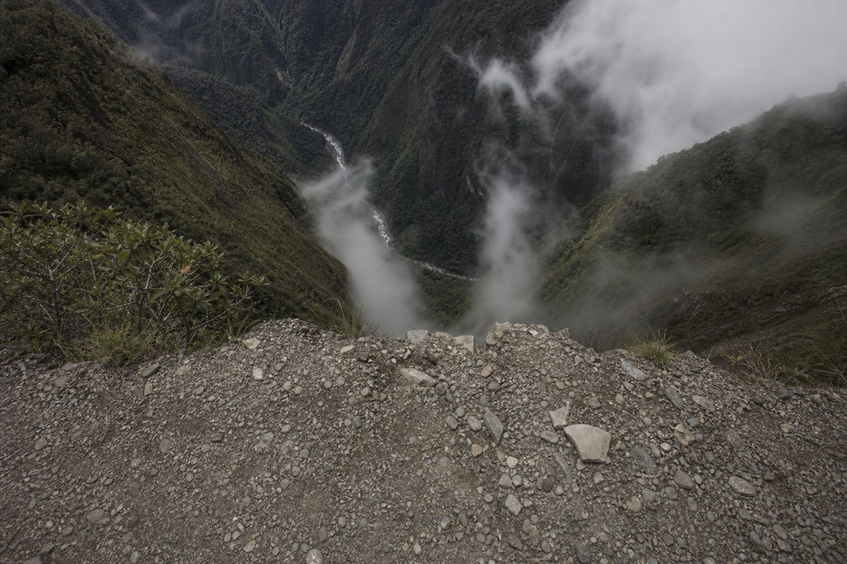 The Death Road dropping away into the deep Yungas valley below